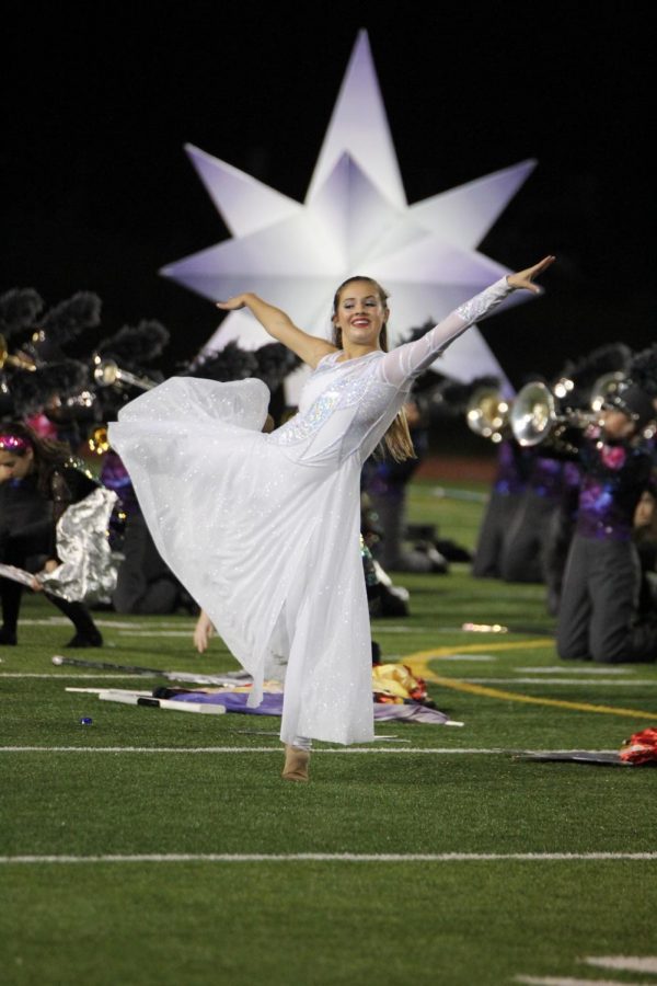 Sarah Christman 20 poses as she completes her routine during half time.