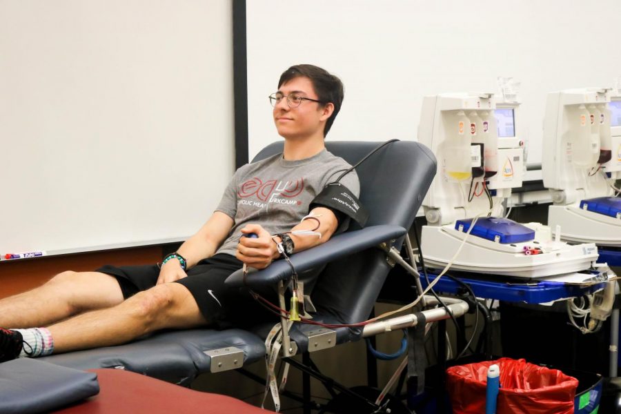 Jack Pitre 19 sits down as he donates blood.