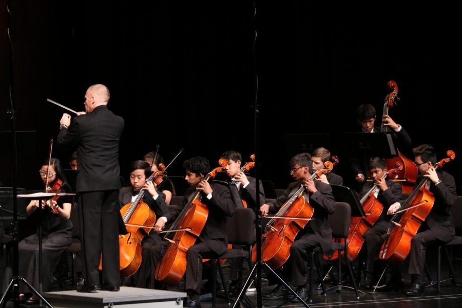 The orchestra director, Mr. Joshua Thompson,  leads Concert during Nabucco Overture, which consists of mostly violinists and cellists.