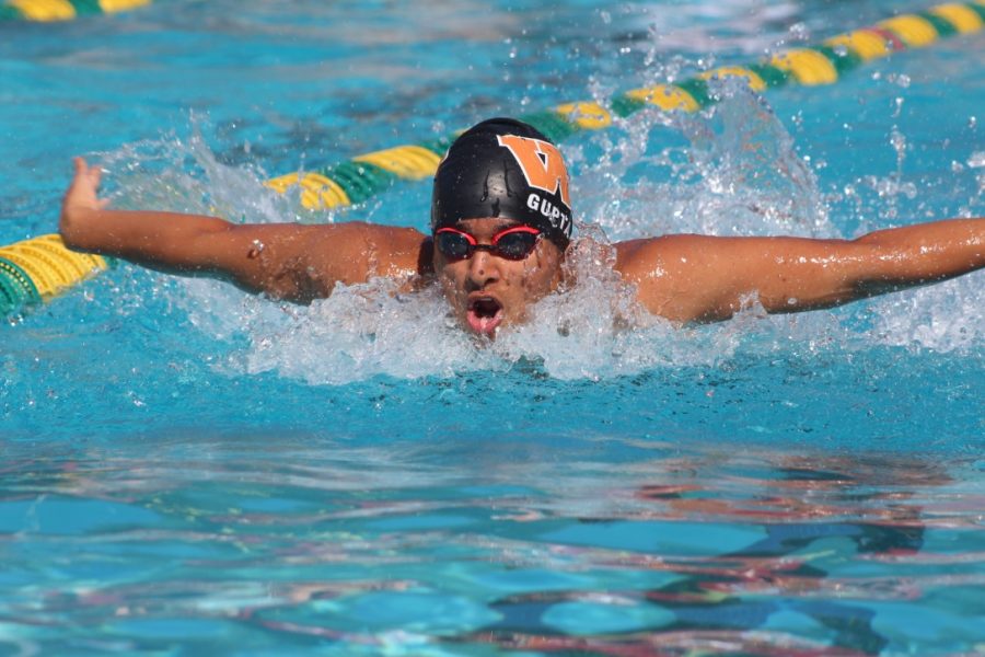 Somil Gupta 19 takes a breath during the 100-meter butterfly. 