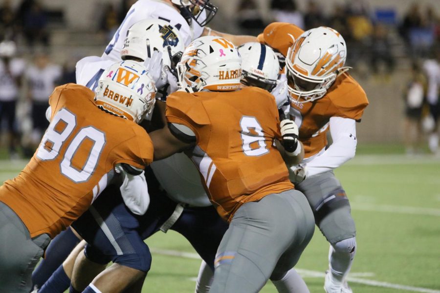 Seniors Ethan Brown and Damon Harris work together to take down a Stony Point running back.