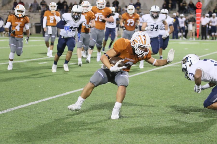 Robbie Jeng 21 raises his hand to block an oncoming Stony Point player.