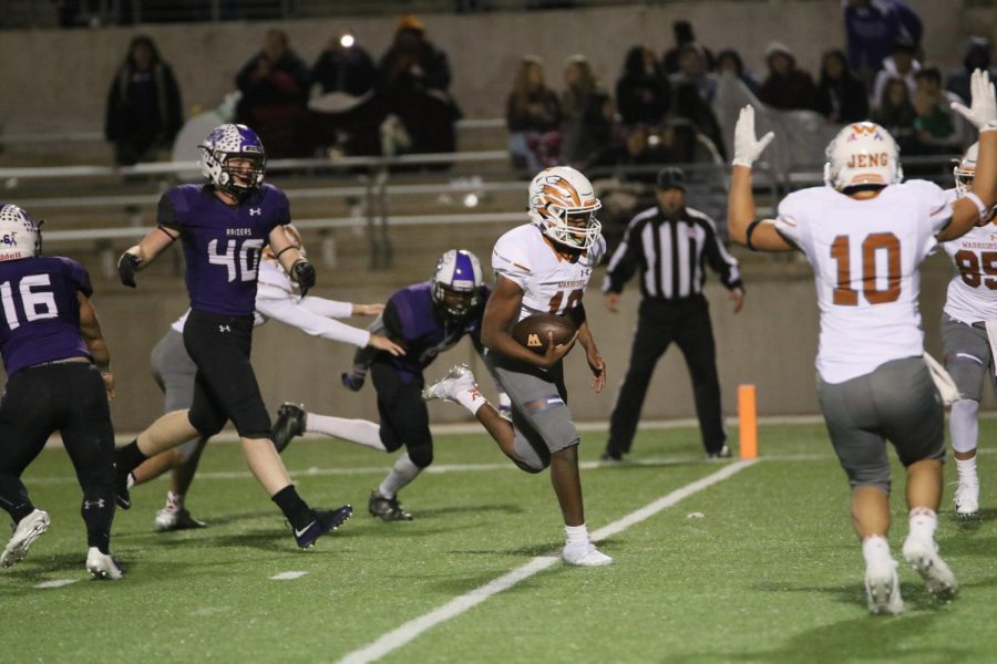 Executing a quarterback keeper, Tavon Ousley 19 finds a hole in the Cedar Ridge defense to score a touchdown.