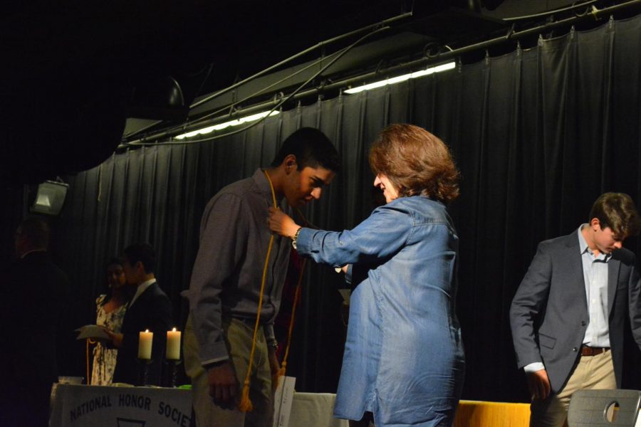 Armaan Reissedonna 20 recieves his cord to mark his induction into NHS.