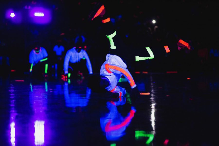 Breakdance club adds neon duct tape to their shirts to make them glow in the dark.