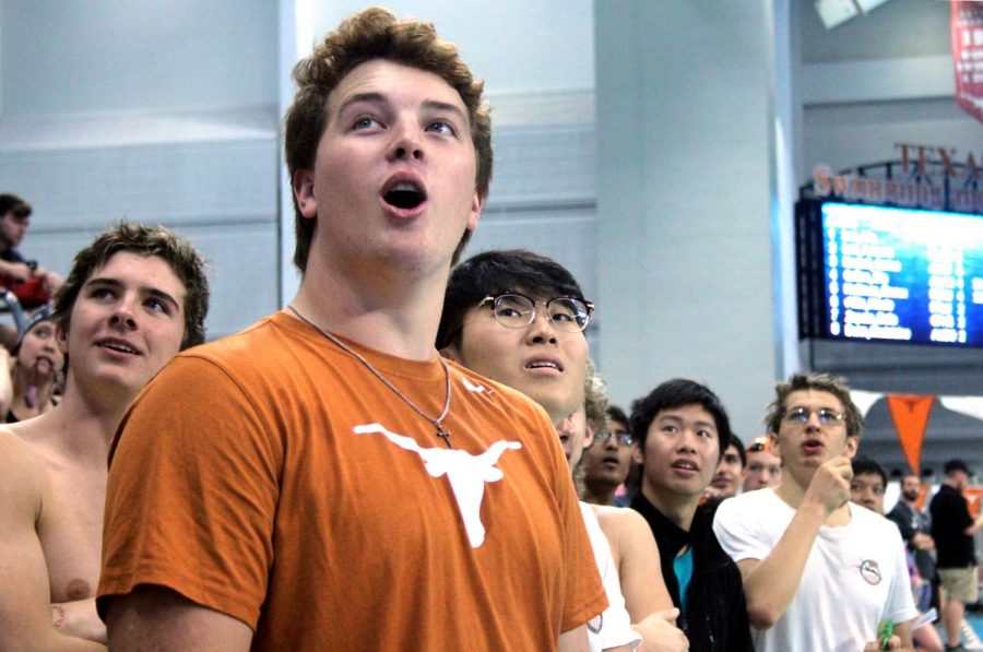 Westwood alum Kyle Varozza 18 and members of the swim team watch as results from the race come in.