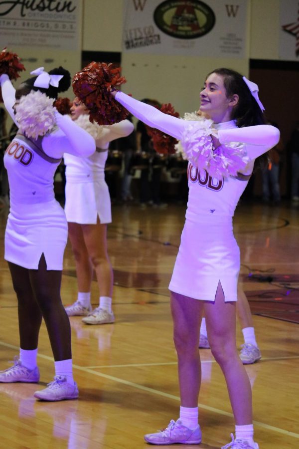 Sophomores Claire Fleming and Ryan Ejuma cheer before the pep rally begins.