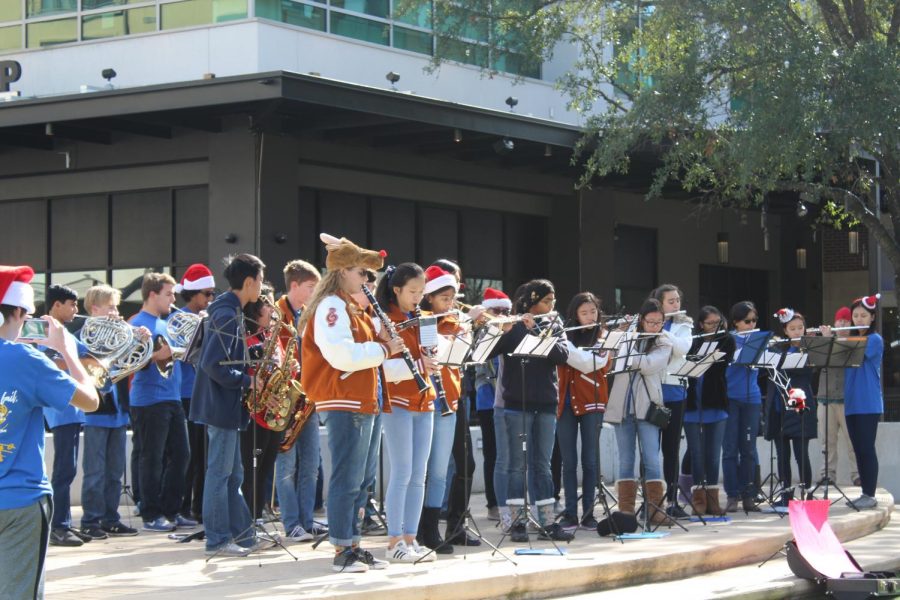 The MUSE Club performs for a crowd in the Domain to raise money for Blue Santa, an organization that gives gifts and toys to children in need.