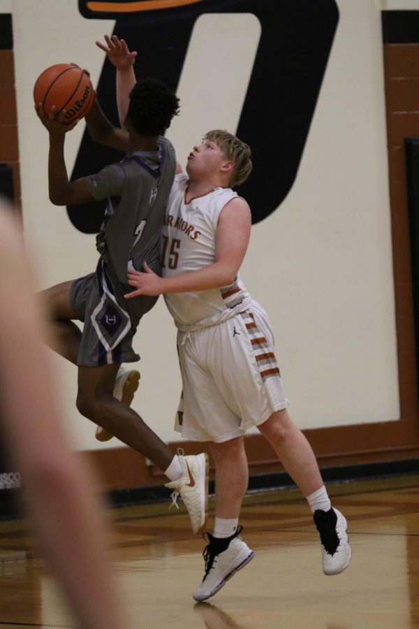 Jake Lacey 20 blocks a Hawk from shooting.
