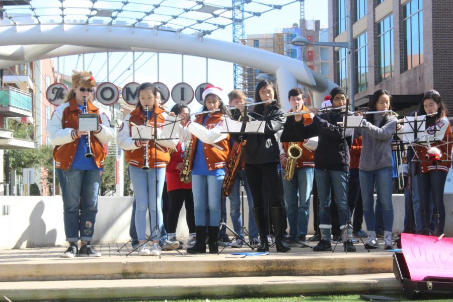 The woodwinds play their instruments for a crowd in the Domain.
