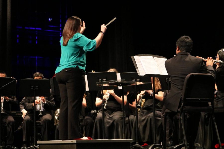 Director Brittany Dacy conducts the Wind Ensemble as they perform.