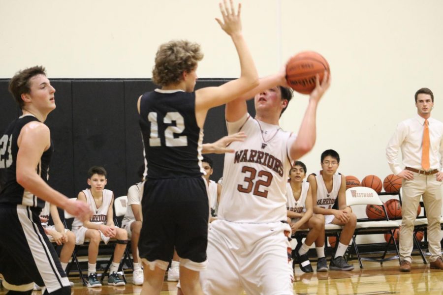 Blocked by an opposing defender, Tate Booknis 22 attempts to shoot.