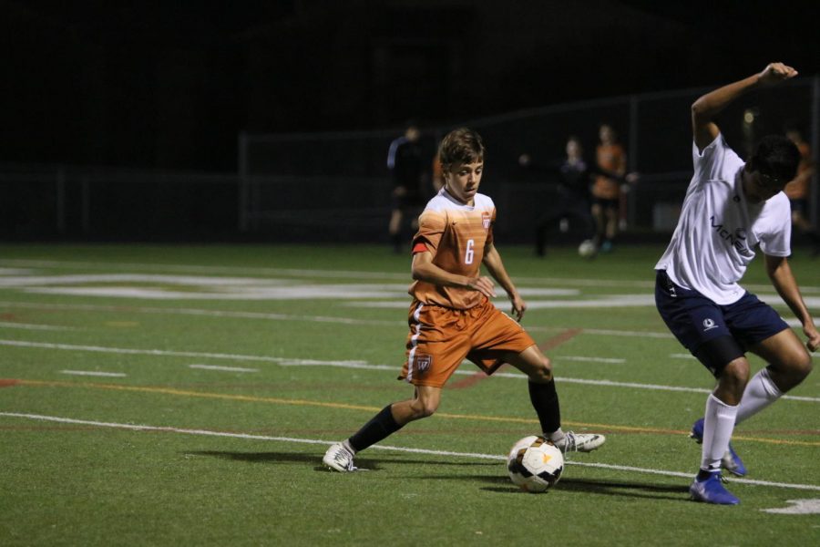 Daniel Brown 21 moves to steal the ball from an opposing McNeil player.
