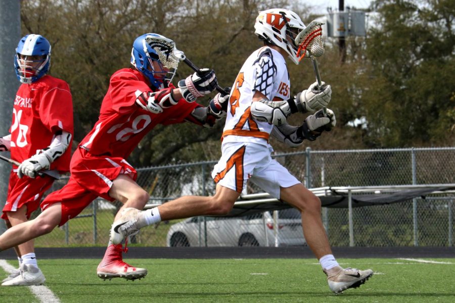 Logan Koteras 20 beats Westlake defenders and heads to the goal.