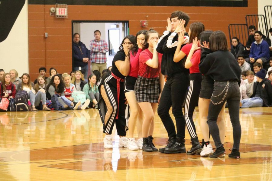 George Rhulman 20, Elizabeth Wolf 20, and others line-up before the beginning of their K-pop dance.