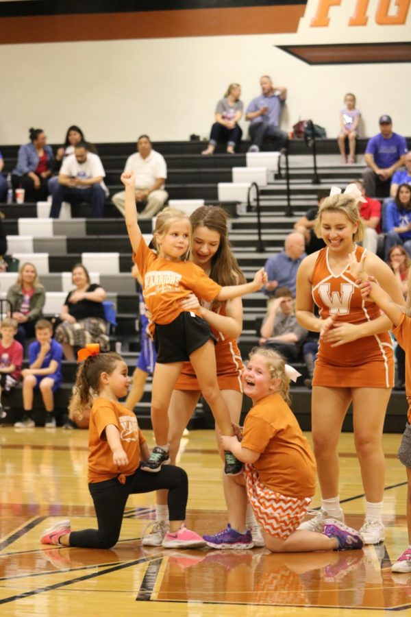 Abby Sandlin 22 and Paige Castillo 20 help three members of the Kiddy Clinic stunt.