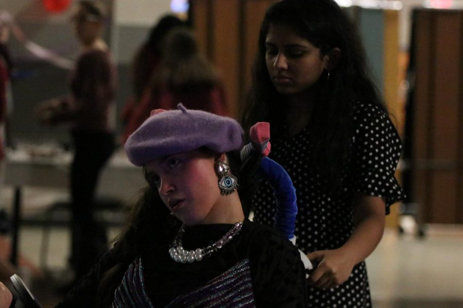 Ridha Mirza 19 walks with her buddy to the arts and crafts area of the dance.