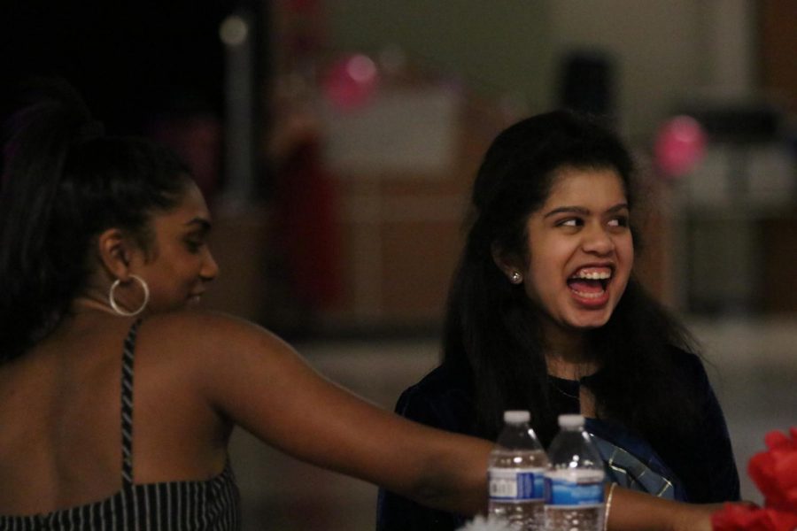 Anjie Ashar 20 cracks jokes with her Ayesha Arni 19 at the annual Valentines Day dance.