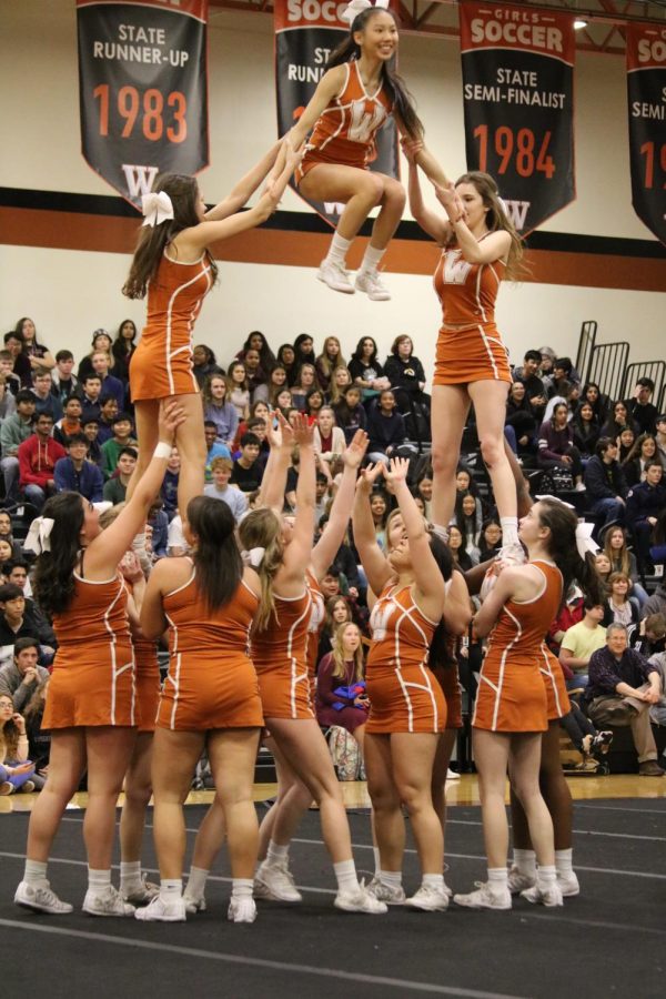Cheerleaders hoist up Violet Rogers 20 during their performance. 