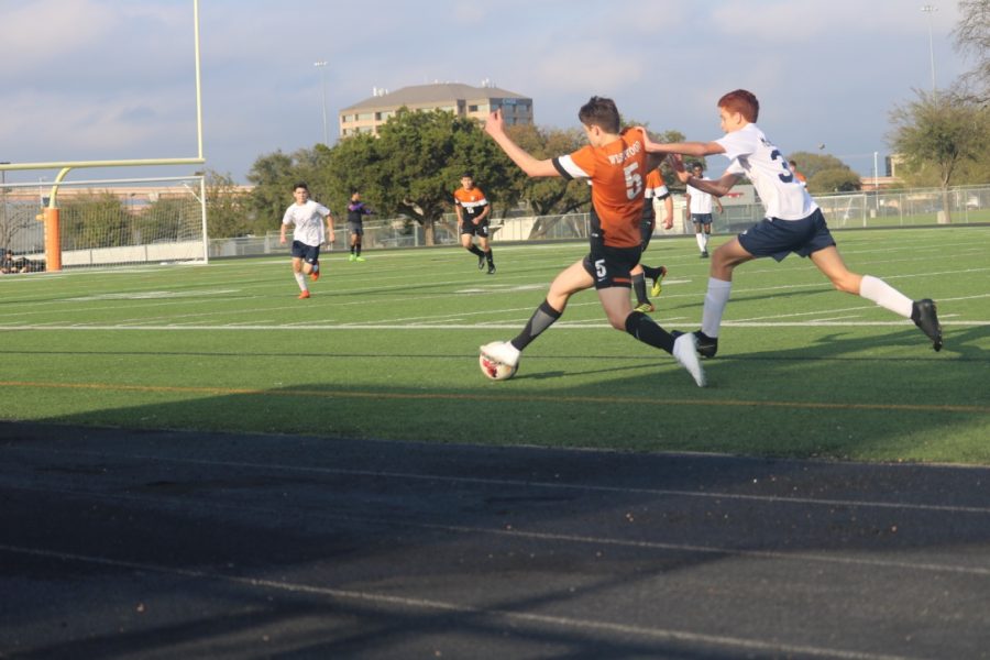 Alexander Swanson 22 sprints to the ball and outruns McNeil player.