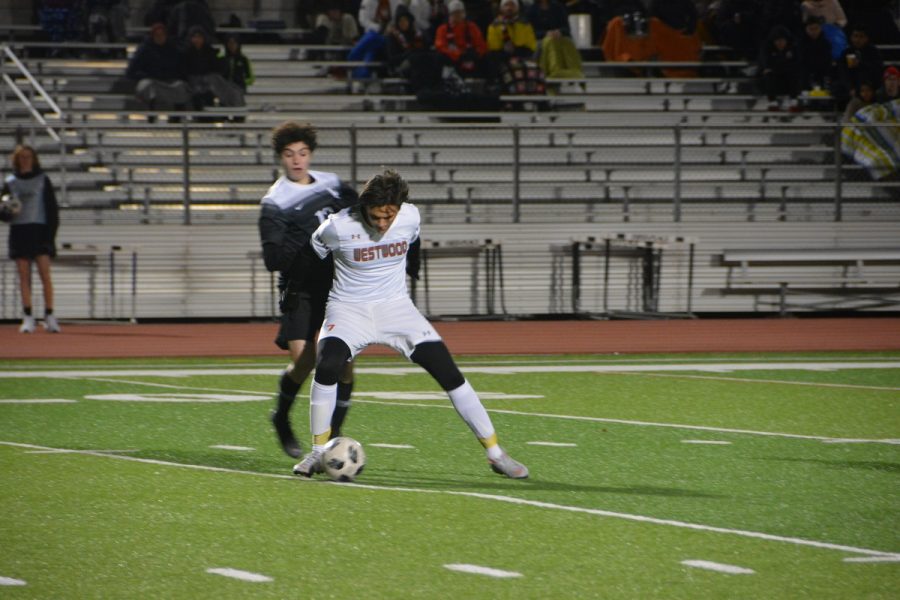 Theo Givens 20 fights for possession with a Vandegrift player.