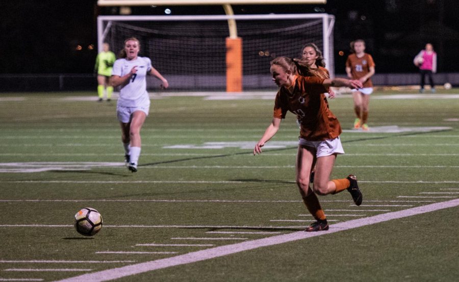 Autumn Koch 19 runs towards the ball.