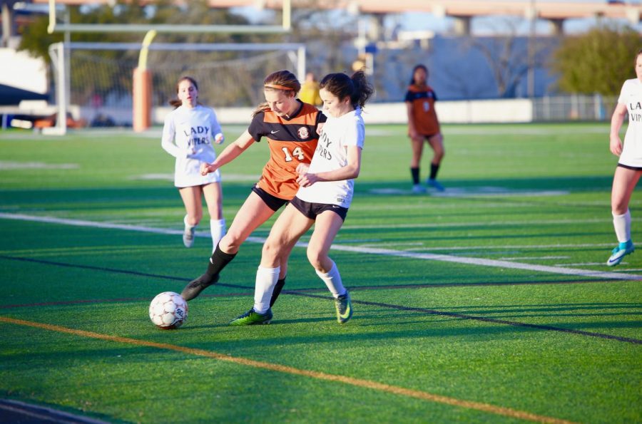 In a game against the Vandegrift Vipers, Izzy Brown 22 attempts to keep the ball away from an opponent.