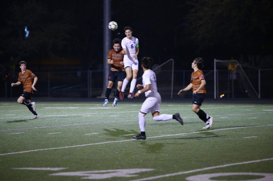 Lalo Rodriguez 19 goes against an opponent to head the ball.