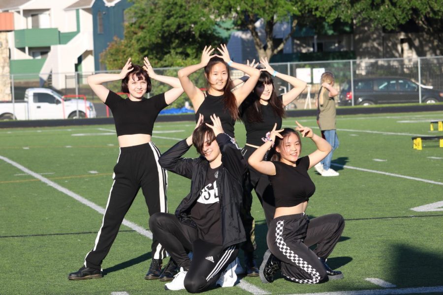 The K-pop club pose together after finishing their performance. 