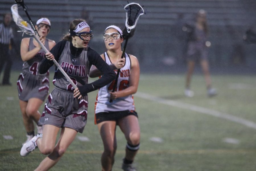 Stephanie Shih 20 eyes the ball in the opponents lacrosse stick.