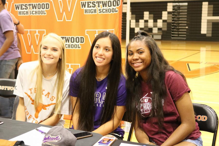 Seniors Alyssa Popelka, Gabby Garcia, and Oni Boodoo pose together during signing.