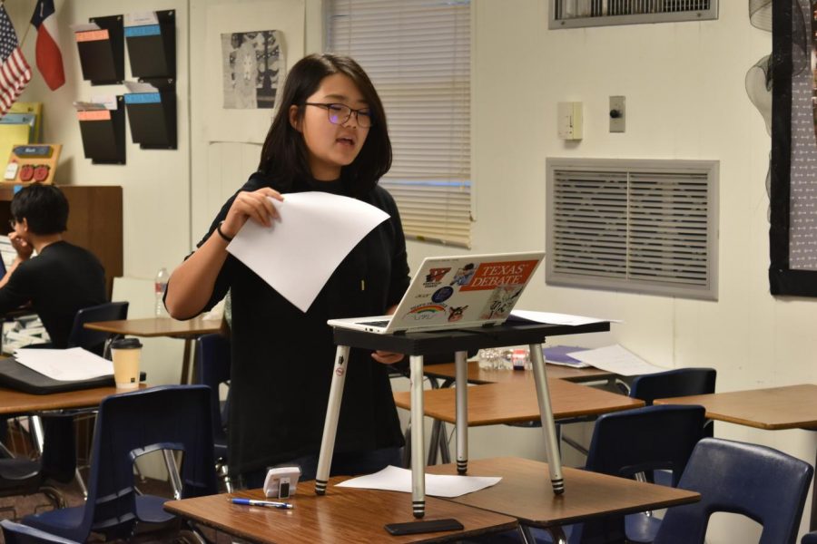 Erith Won 22 reads from her laptop. Photo courtesy of WHS Speech and Debate.
