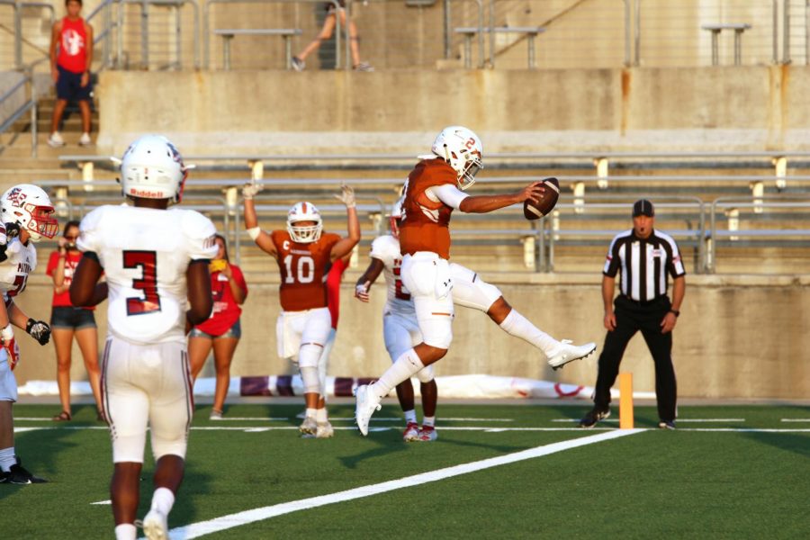 Leaping into the end zone, RJ Martinez 21 begins to celebrate his touchdown. Martinez scored the first touchdown of both the game and the Warriors season. “It felt good obviously, bringing a little bit of excitement to the crowd and our team because we really needed that. Good job to the O-line up front. You know it all starts with them. They made the hole for me, I just kind of scrambled through and I got it,” Martinez said. 