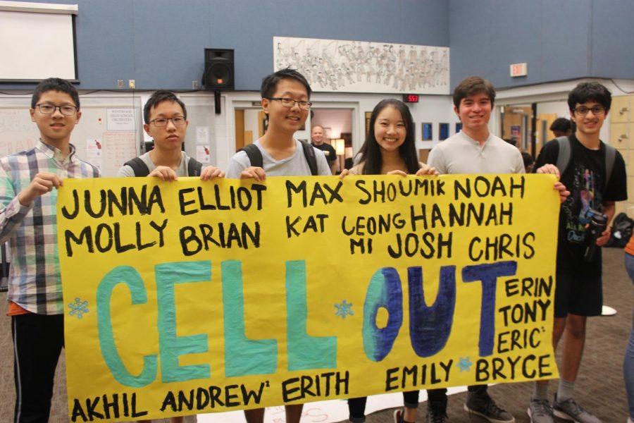 The cellists proudly hold their finished poster which they spent so long making.  They used play-on words to say cell out, trying to say chill out using the word cello.