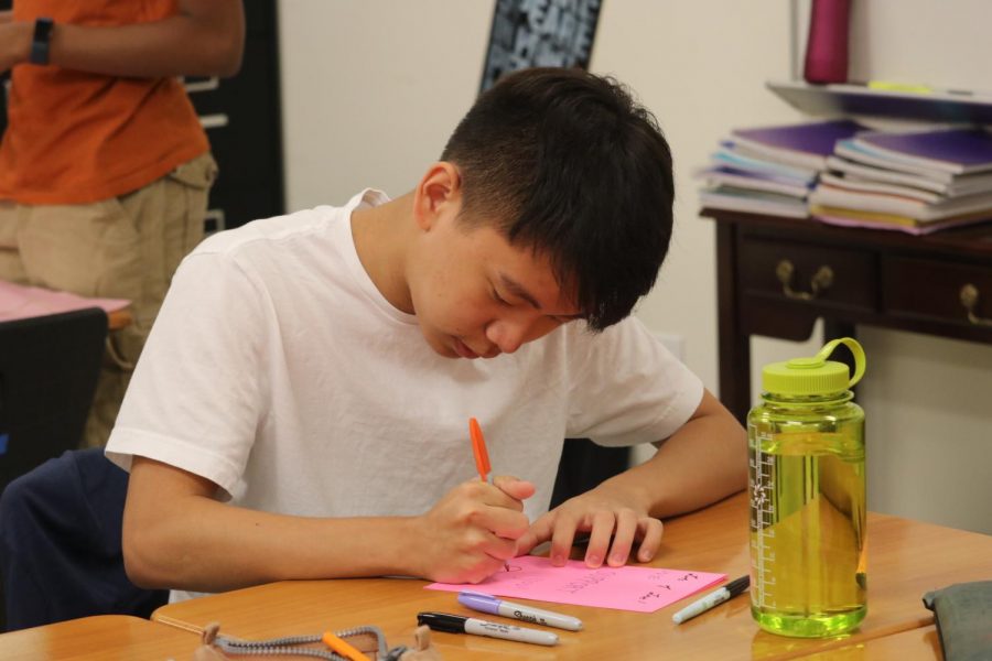 Minshin Kim 21 focuses on his homemade card for the El Paso students. 