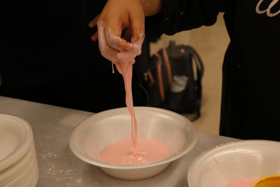 Jenny Tran 20 shows off her finished oobleck that acts like a solid when stretched out.
