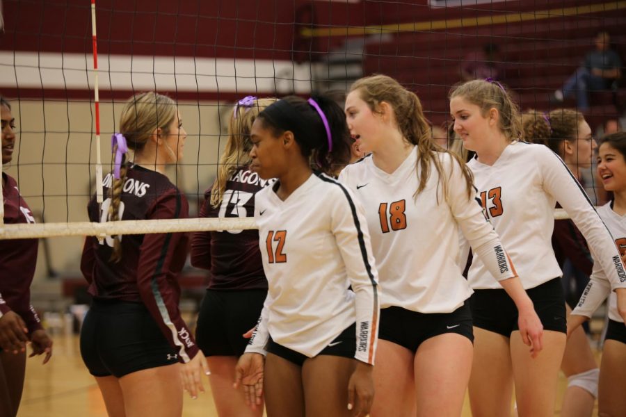 Outside hitter Peyton Ferree 22 and middle blockers Mckayla Ross 22 and Madeline Shrull 21 congratulate their opponents for a good game. The Warriors were behind five points, and in a last ditch effort, managed to catch up and finish the third set with a win.