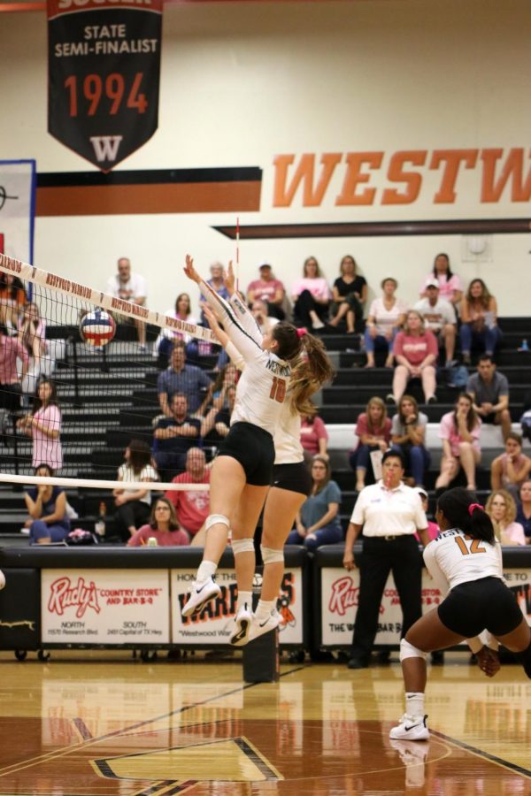 Seniors Audrey Quesnel and Zoe Menendez jump to block the ball. Quesnel and Menendez were successful in blocking the ball and the play ended with the Lady Warriors socking a point.