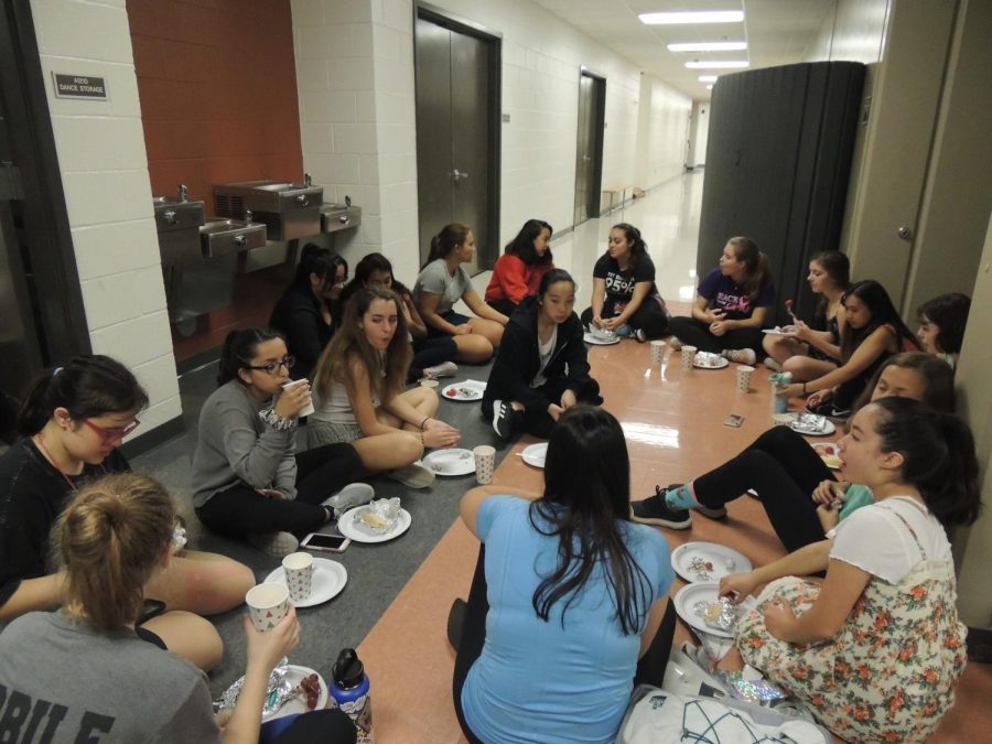 Warrior Pride and SunDancers socialize in the dance hallway while eating breakfast. Both dance teams dance together only for the Homecoming production, so they took this opportunity to bond and get to know each other better.