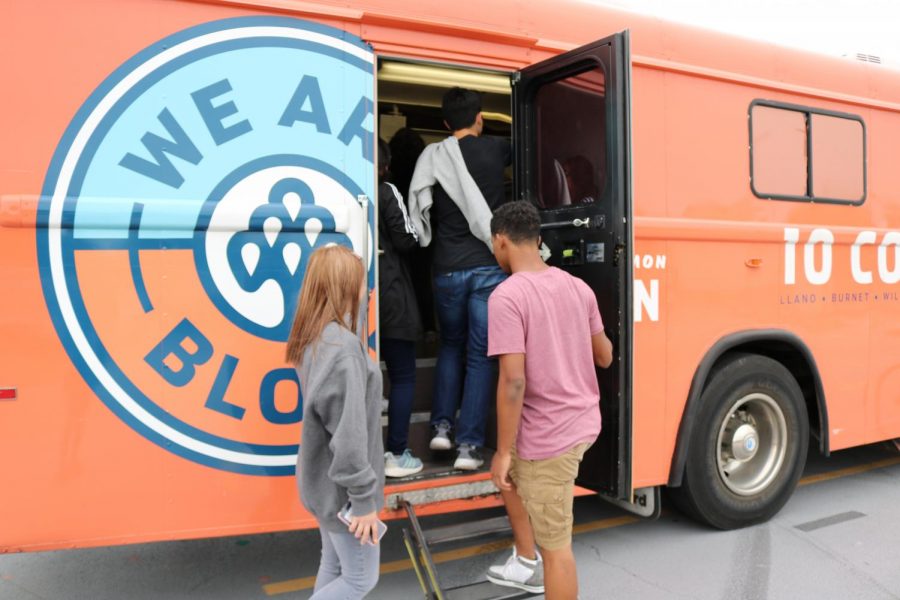 Students eager to donate blood climb into the crowded bus where they await their turn.
