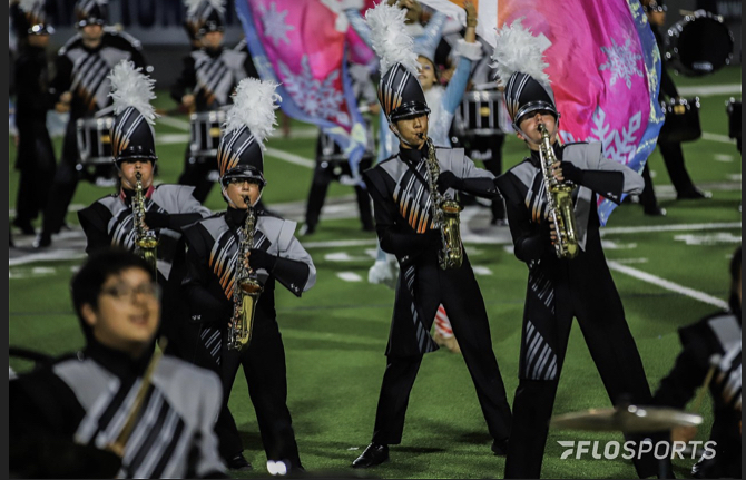 The saxes play through the woodwind feature. While the brass is on the other side of the field doing choreography, the woodwinds play a fast and technical feature. Photo courtesy of FloMarching.