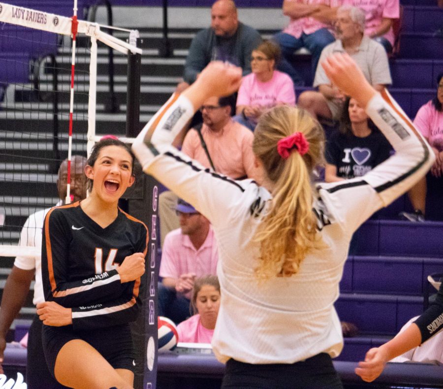 Zoe Menendez 20 celebrates with captain Maddie Gillispie 20. They had just scored a critical point near the end of the first set.