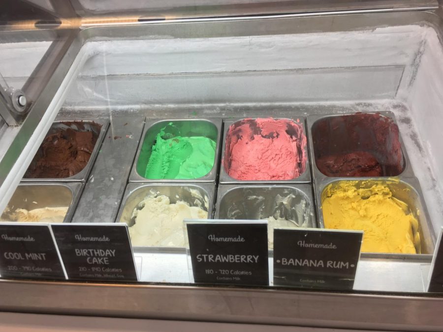 A rainbow array of ice cream flavors is displayed behind the glass at Marble Slab Creamery.