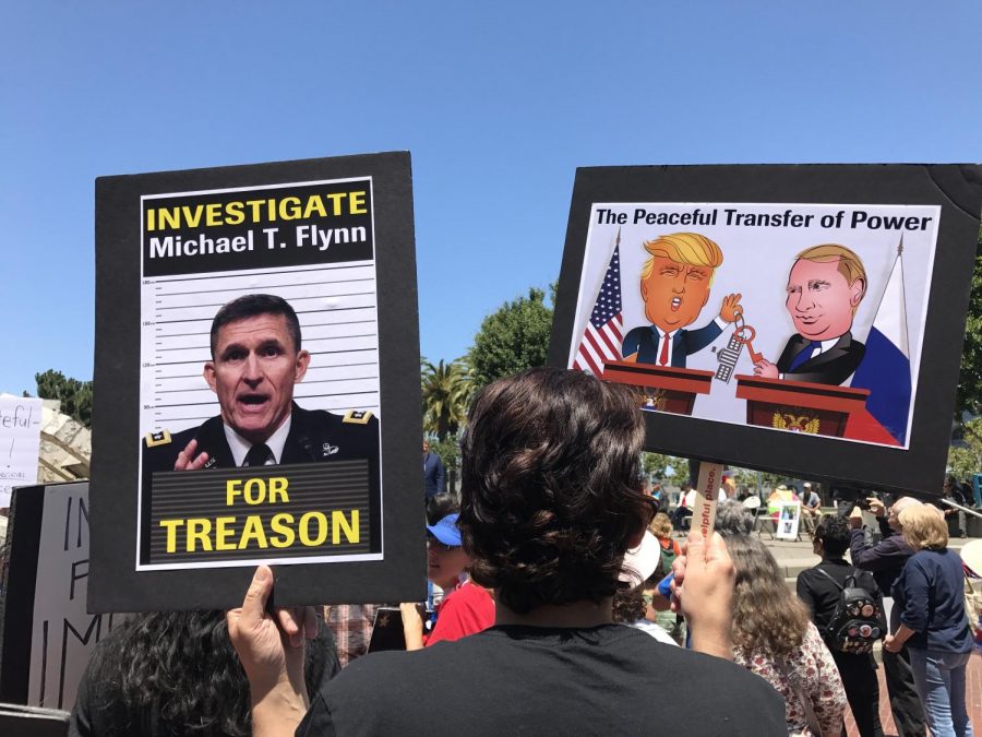 At the Impeachment March on July 2, 2017, a participant holds up signs protesting the Trump administrations relationship with Russia.