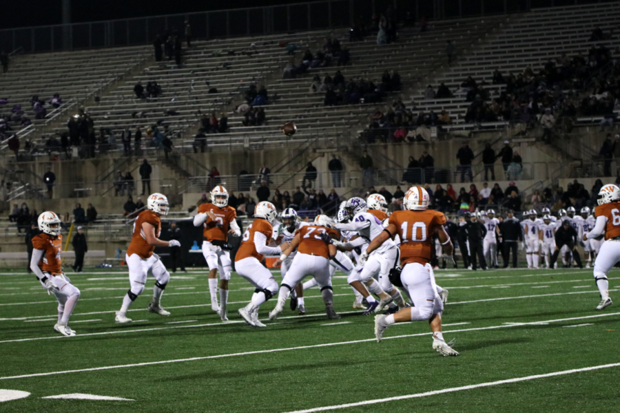 RJ Martinez 21 passes the ball to wide receiver Robbie Jeng 21. Martinez set a record by having the most passing attempts in a Texas high school football game, with a total of 76 passes in this match against Cedar Ridge.