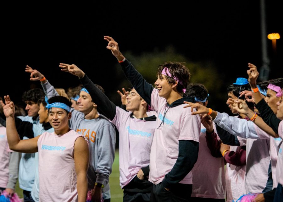 Guillermo Ruiz Ortiz ‘21 makes a “W” for the Westwood Song. Dressed in pink or blue t-shirts and bandanas to signify their grade’s team, the powderpuff cheerleaders cheered on the game.
