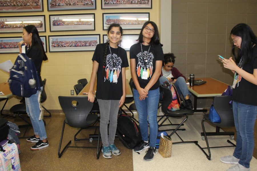 After getting their schedule for the day and signing in, Rakshinee Srikanth 22 and Diya Rajon 22 head to their assigned rooms to prepare for the 8th graders to come.  