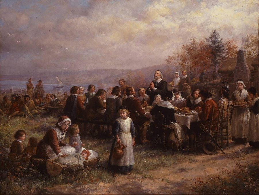 Native+Americans+and+Pilgrims+share+a+feast+at+a+depiction+of+the+first+Thanksgiving.+The+first+Thanksgiving+was+held+in+October+1621.