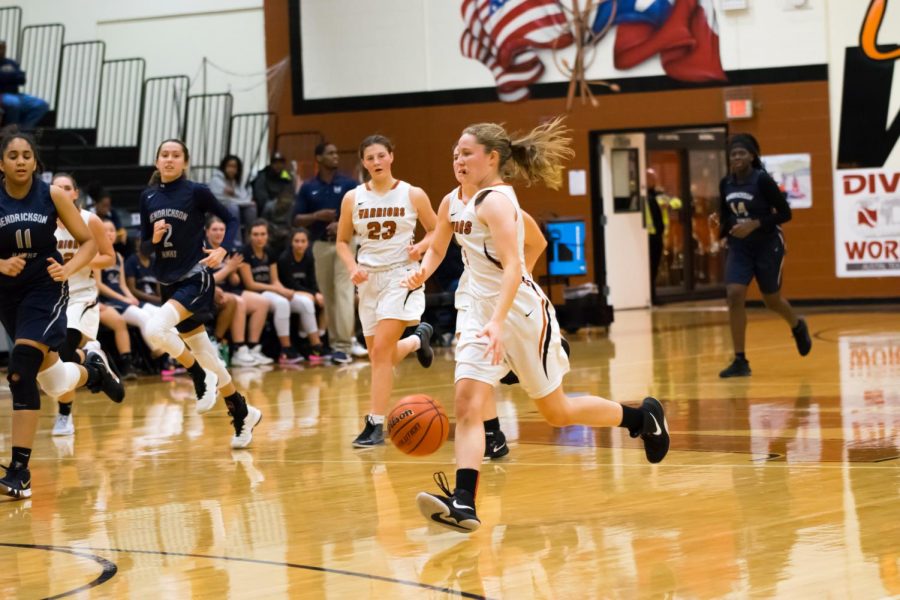 Emma Goolsbey 21 dribbles the ball down the court. Goolsbey would score several 2-pointers throughout the game.