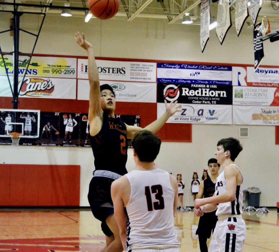 With a defender in his way, Justin Chen 20 shoots a floater. However, Chen was called for a charging foul, negating the basket and giving the ball to Vista Ridge.